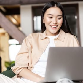 happy-asian-woman-resting-at-home-with-laptop-wat-2022-08-14-04-58-22-utc.jpg